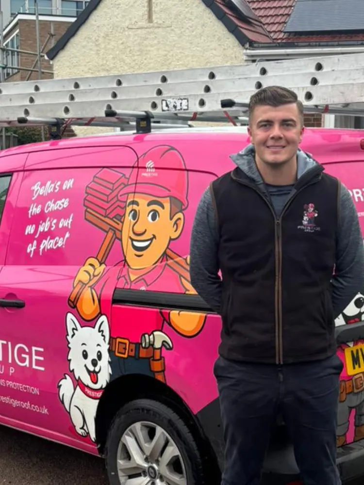 Luke, who runs Prestige Roof, standing beside one of the firm's pink vans