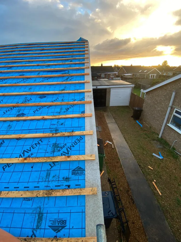 Breathable membrane and new battens going on at sunset