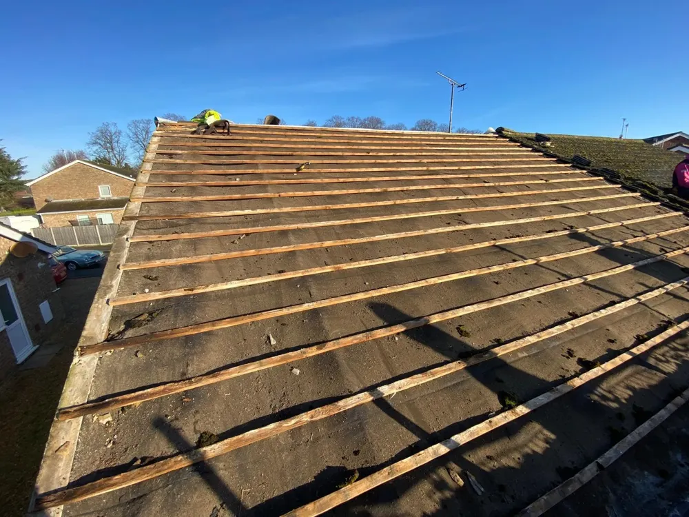 An old roof stripped back to the battens before re-tiling